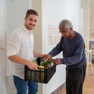 young carer helping and elderly man